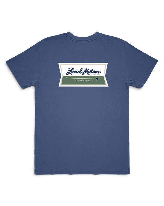 A blue short-sleeve t-shirt with a rectangular chest graphic that reads 'Local Motion' in white script over a green block, displayed on a clean white background. [vintage blue]