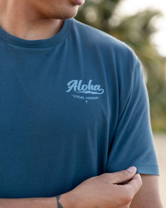 A close-up of a person wearing a slate blue crewneck t-shirt [indigo]