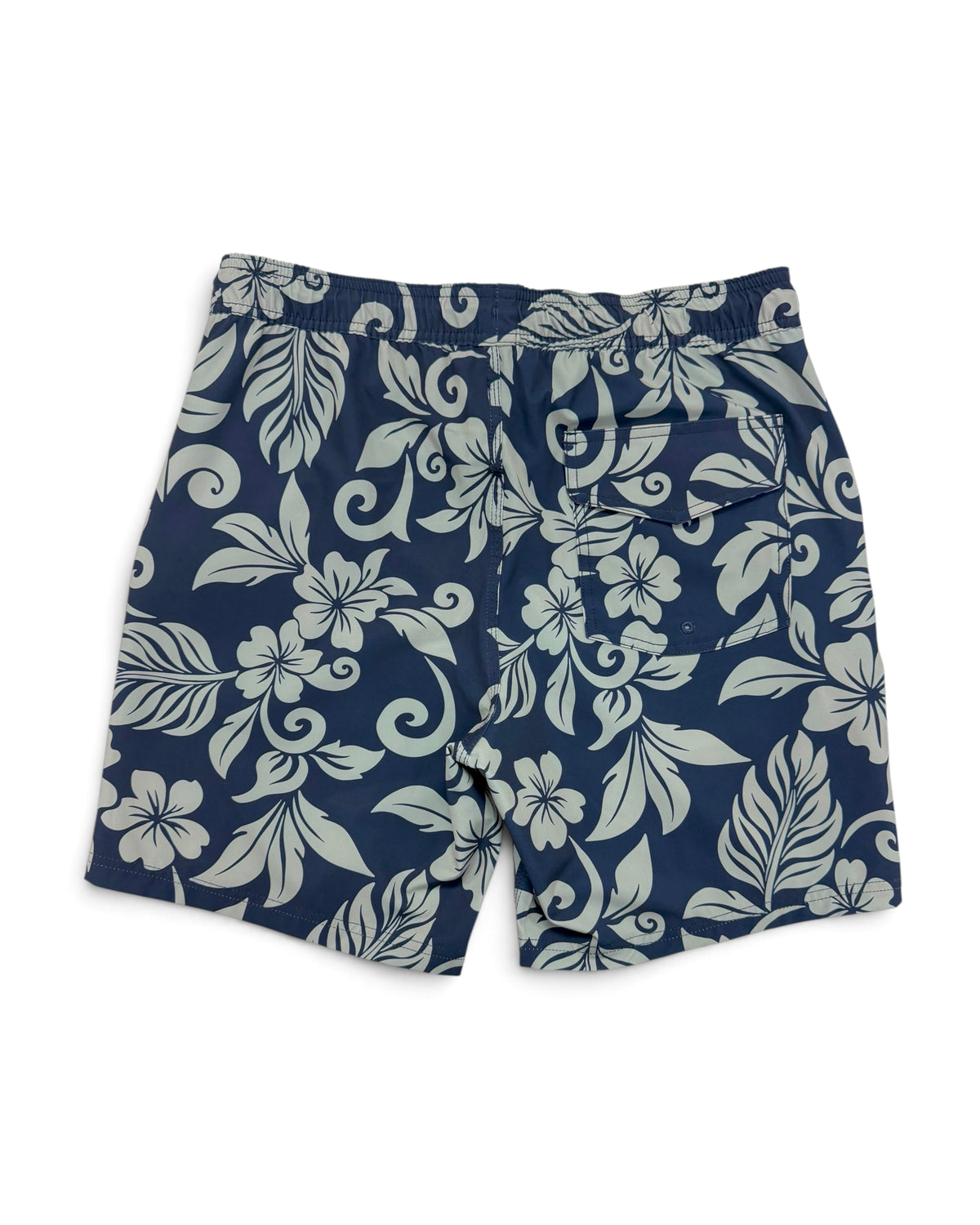 A pair of navy blue swim trunks with a light gray floral and leaf pattern, laid flat on a white background. [deep sea]