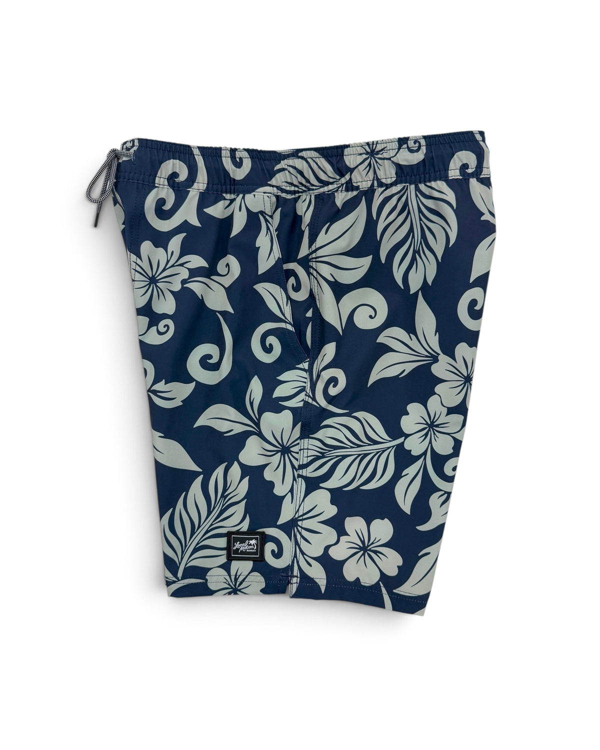 Navy blue swim trunks with a light gray floral and scroll pattern, featuring a drawstring waist and a small black brand patch near the bottom hem. [deep sea]