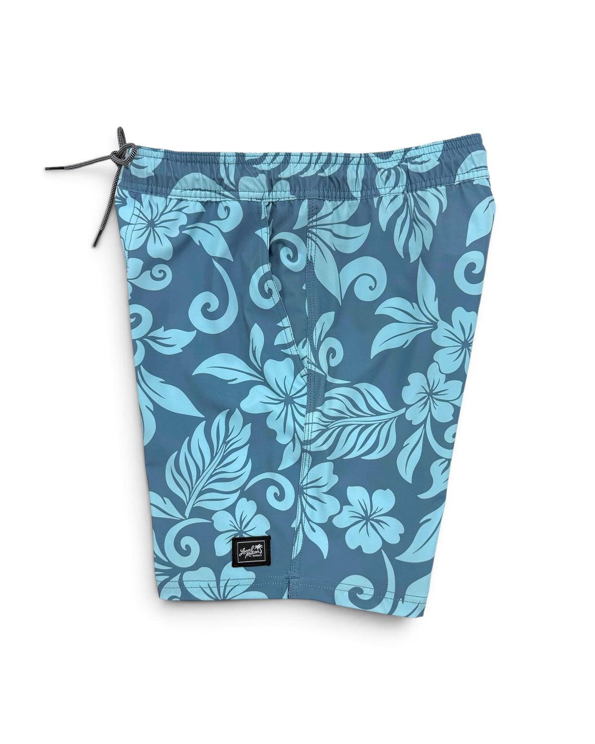 Blue and light blue floral print board shorts with a black drawstring and a small black brand patch near the bottom hem, shown on a plain white background. [pacific blue]