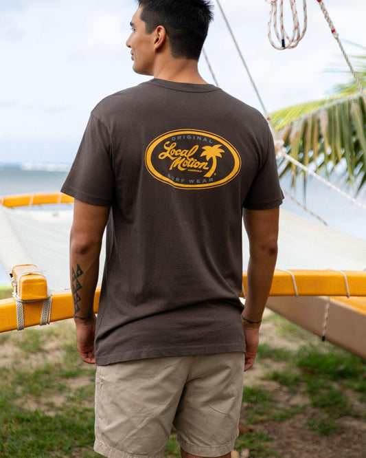 A man wearing a dark brown t-shirt with a yellow graphic on the back [chocolate]