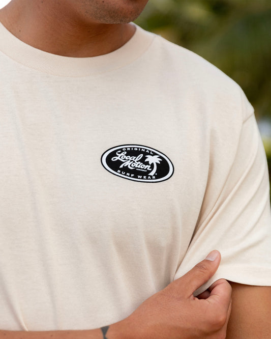 A close-up of a person wearing a cream-colored t-shirt [parchment]