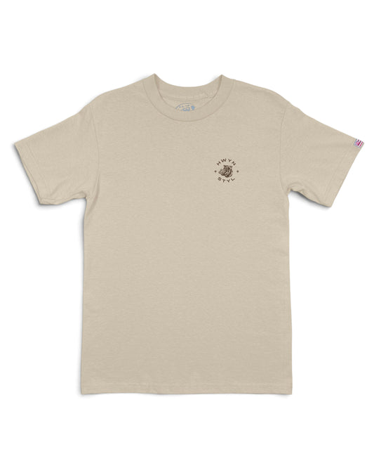 A light beige crewneck t-shirt with a small circular graphic on the left chest [sand]