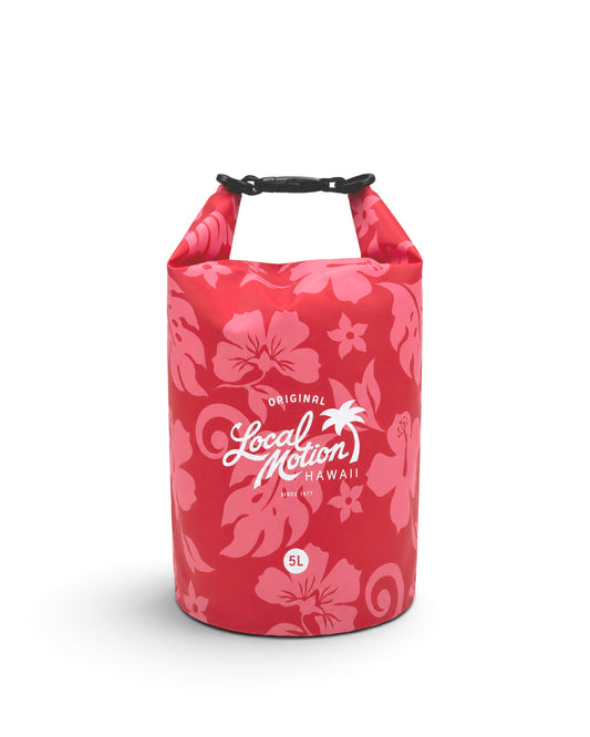 A red dry bag with a pink hibiscus flower pattern, featuring the white 'Local Motion Hawaii' logo on the front, set against a plain white background. [red/beach]