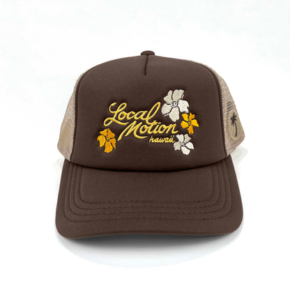 Brown and beige cap with 'Local Motion Hawaii' text and floral designs on a white background