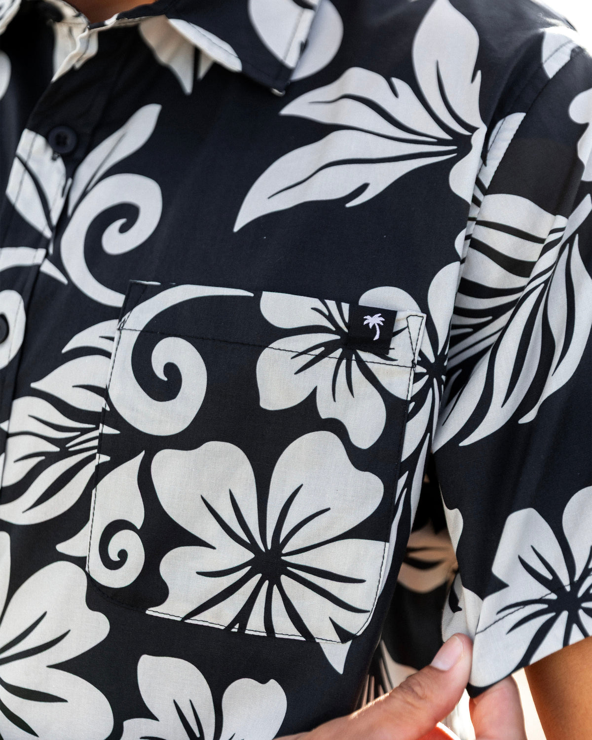 Close-up of a short-sleeve button-up shirt with a bold black and white print [black]