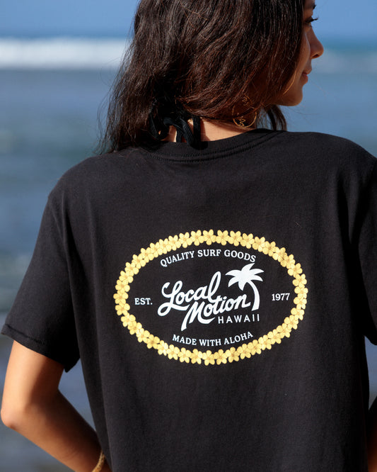 A woman viewed from behind wearing a black t-shirt with a large white and yellow graphic on the back [black]