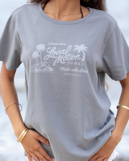 A woman wearing a light gray short-sleeve graphic t-shirt [slate blue]
