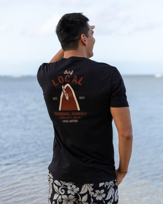 A man wearing a black t-shirt with a brown and orange graphic on the back [black]