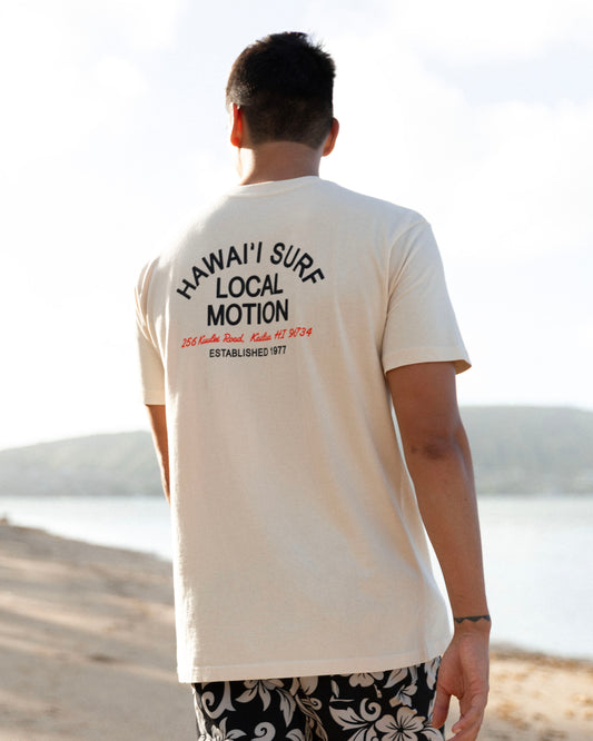 A shot of the back of a shirt on a man in front of a beach [parchment]