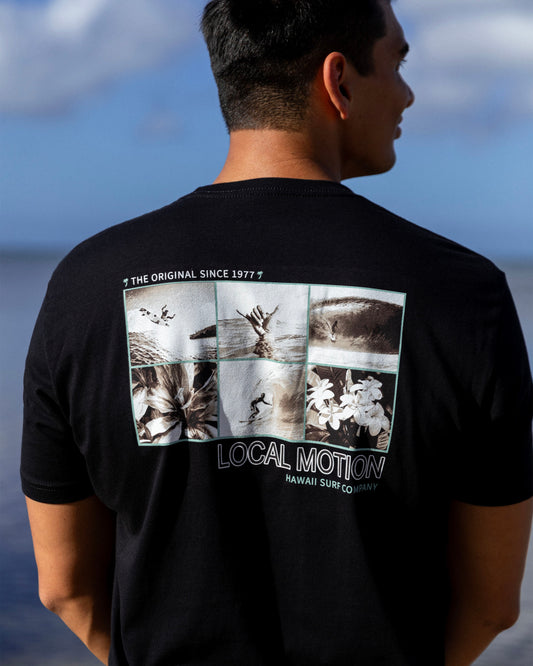 A man viewed from behind wearing a black t-shirt [black]