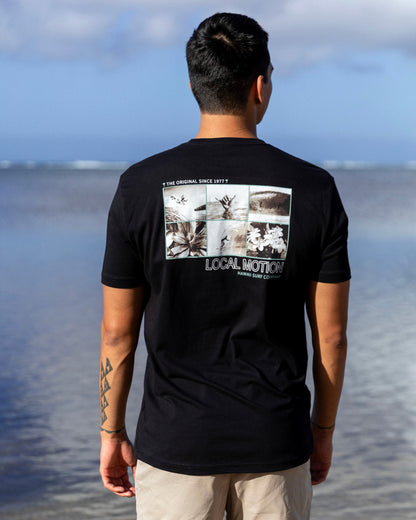 A man viewed from behind wearing a black t-shirt [black]