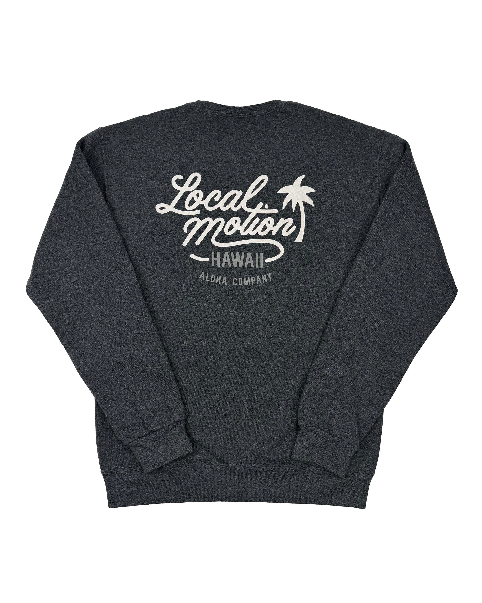 A dark heather gray crewneck sweatshirt shown from the back, featuring a white graphic print that reads 'Local Motion Hawaii Aloha Company' with a palm tree illustration.